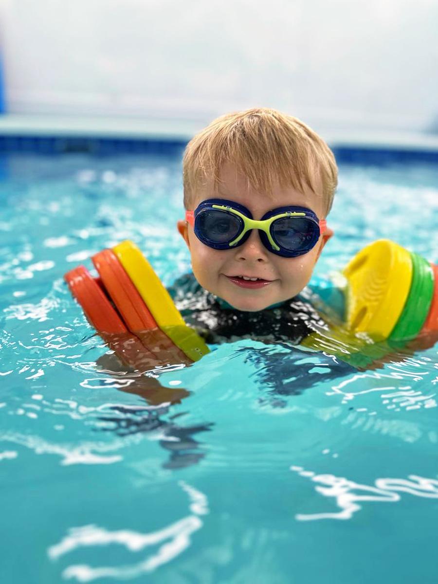 Young swimmer wearing goggles in the Making Waves teaching pool